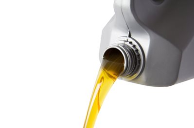 pouring motor oil from silver plastic gallon bottle