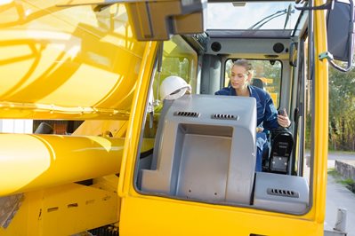 factory female worker operating a crane