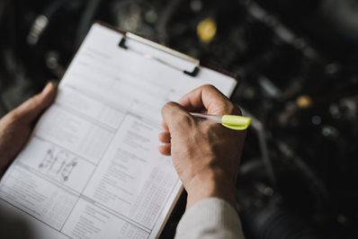 man taking notes on a book